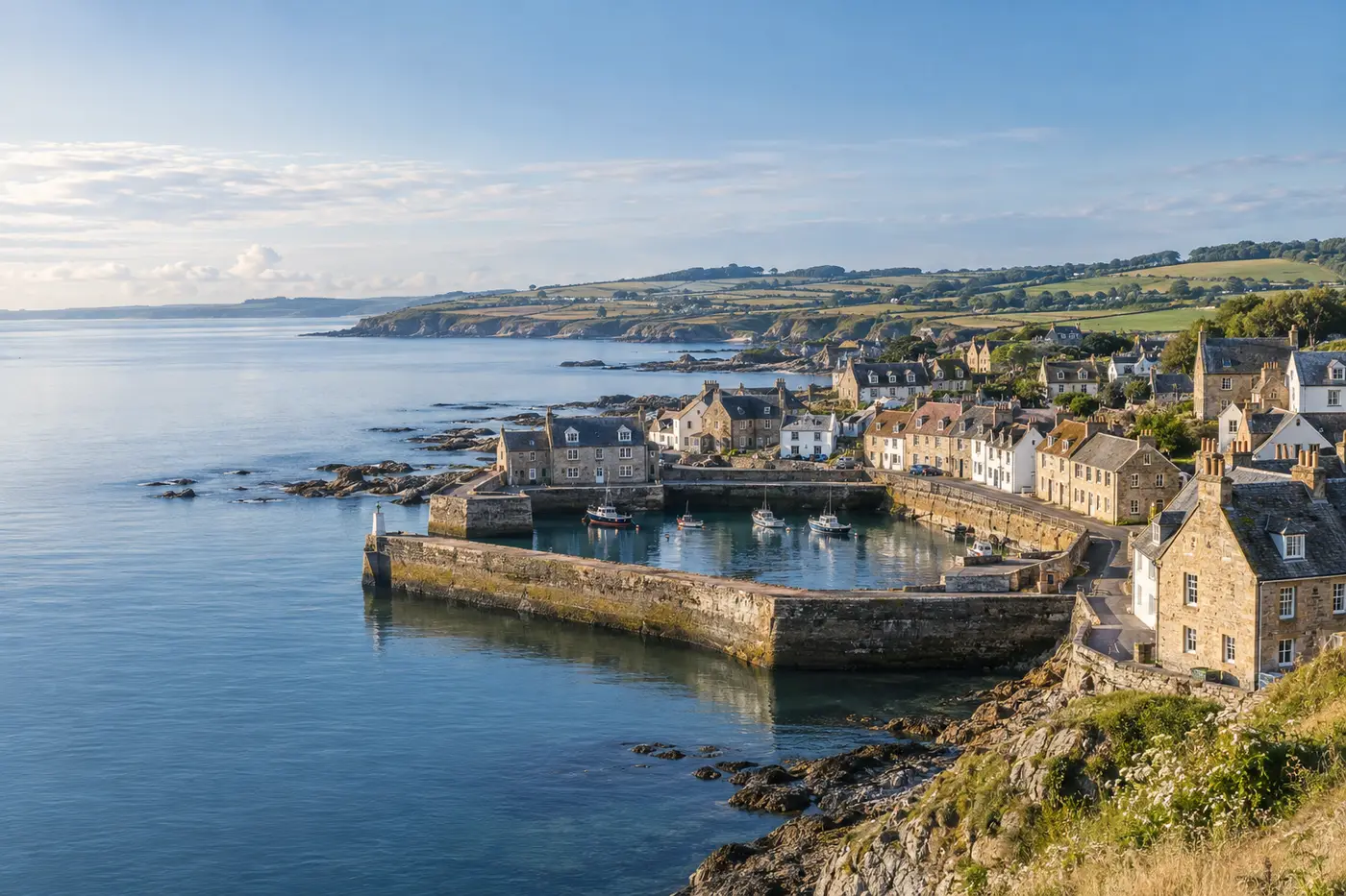An illustrative Scottish coastal village with a stone harbour